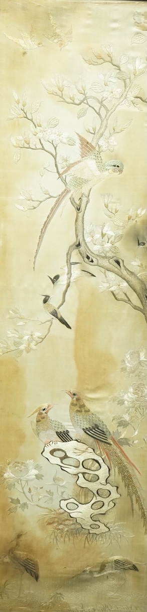 A pair of Chinese embroidered ‘Hundred Bird’ silkwork pictures, c. 1900, in Hongmu and mother-of-pearl inlaid frames, total size 99cm x 32cm. Condition - dark staining and tears to the silk, losses to the mother of pearl
